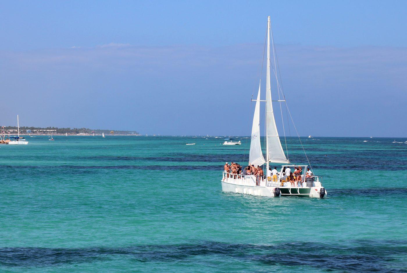 Sailing catamaran full of passengers on the turquoise water off Punta Cana